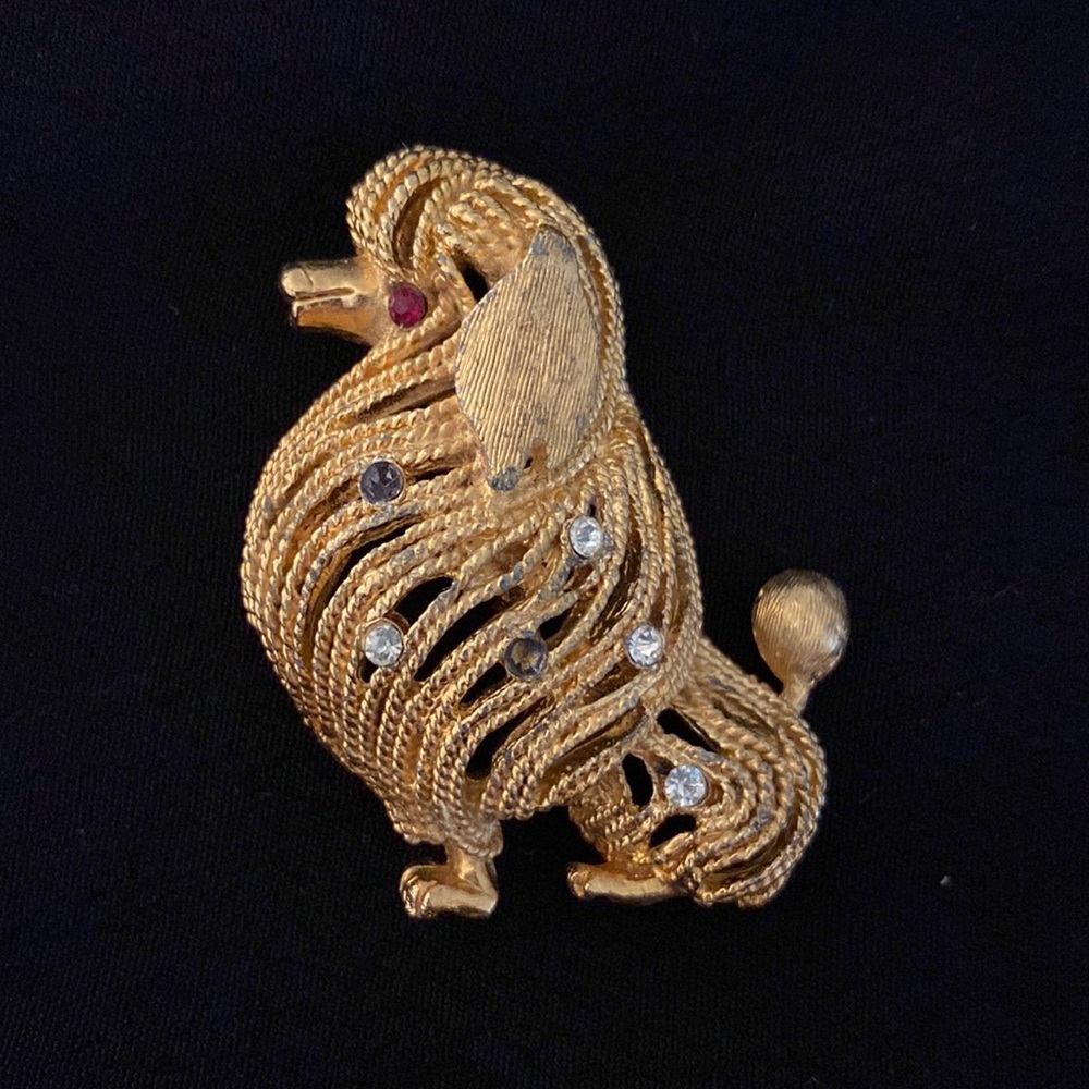 Gold colored poodle pin with colored faux stones